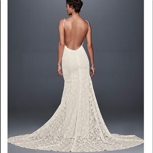 New with tags wedding lace gown. Sexy open back light weight